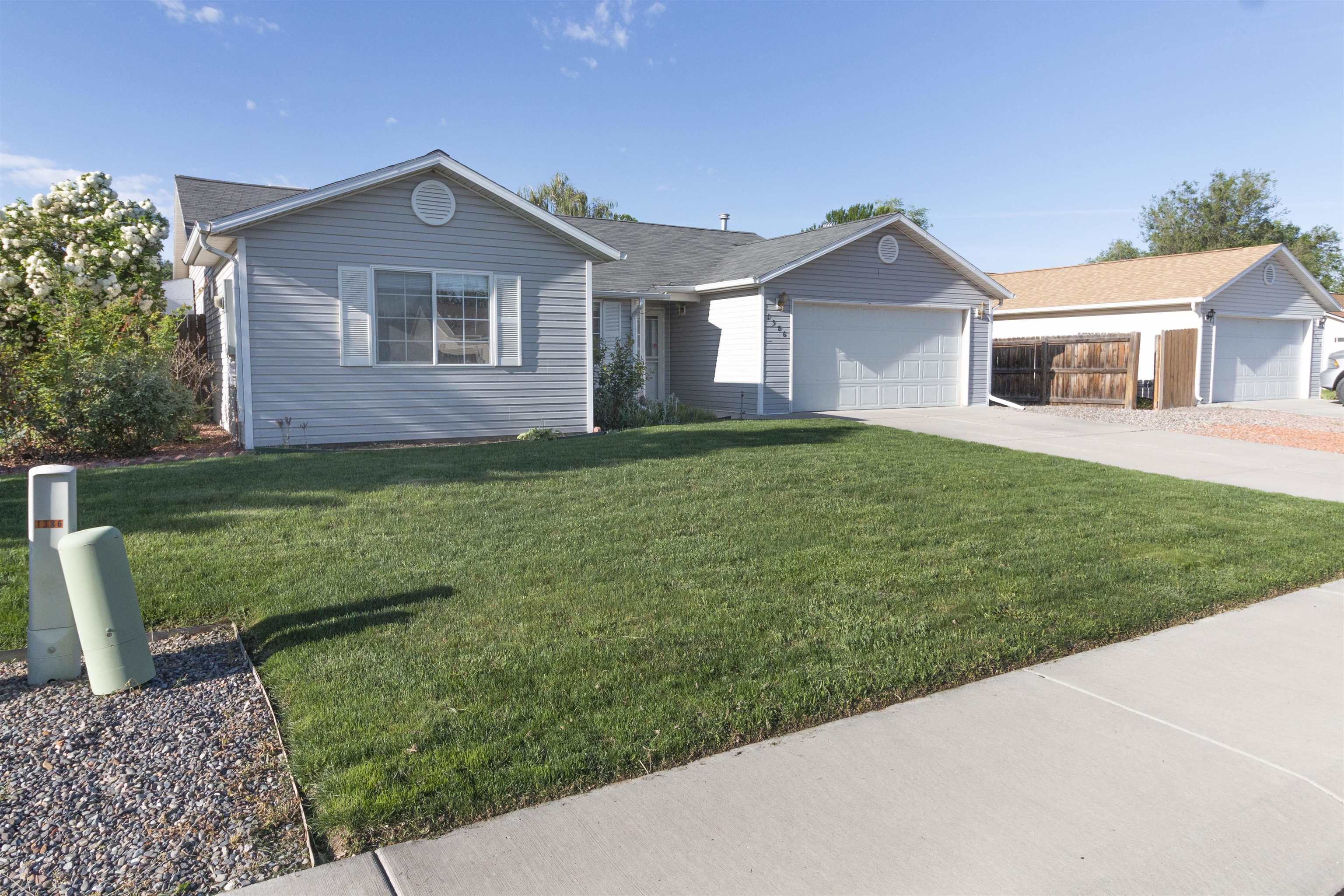 1386 Powell Street Fruita, CO 81521 - Photo 2 of 21 a front view of a house with a yard