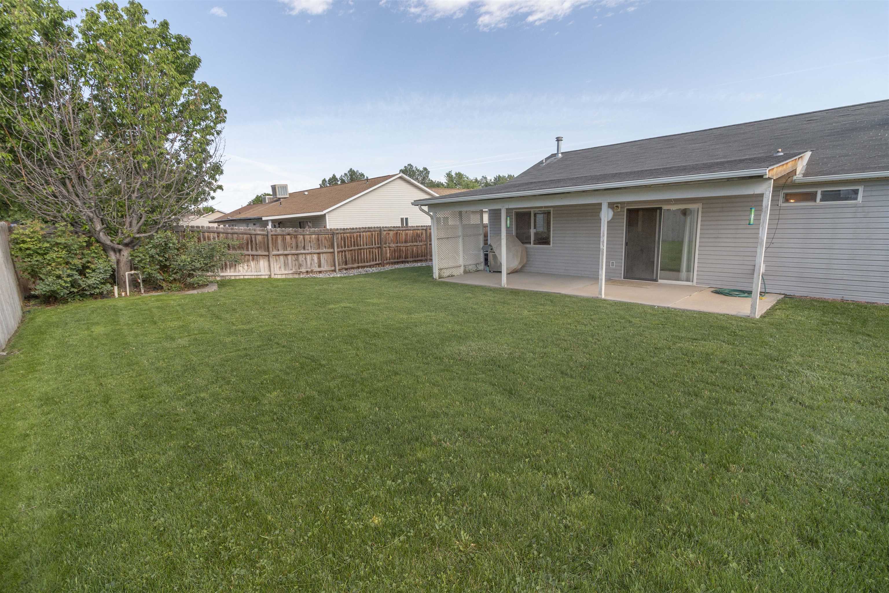 1386 Powell Street Fruita, CO 81521 - Photo 21 of 21 a front view of a house with a garden