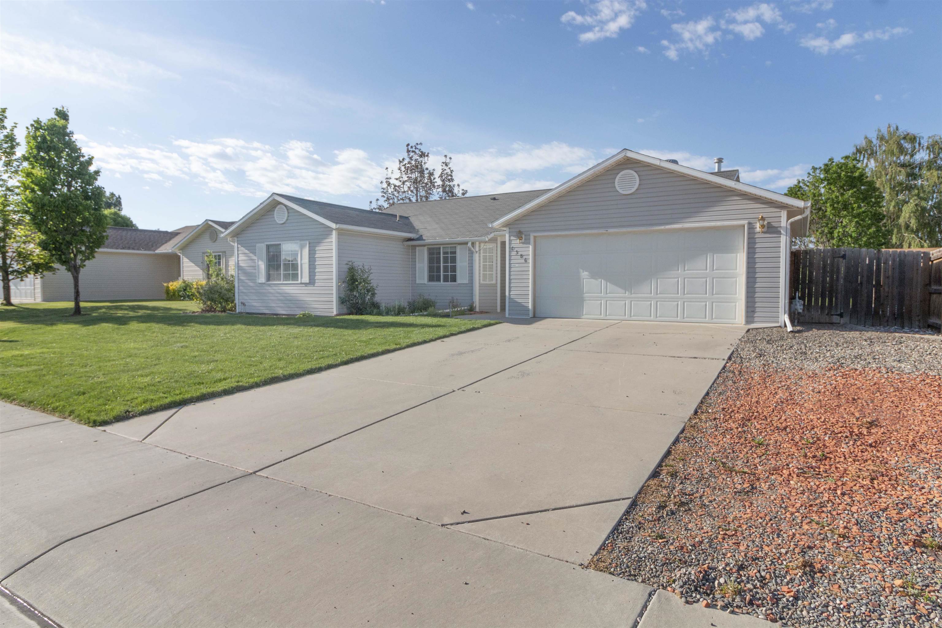 1386 Powell Street Fruita, CO 81521 - Photo 3 of 21 a front view of a house with a yard and garage