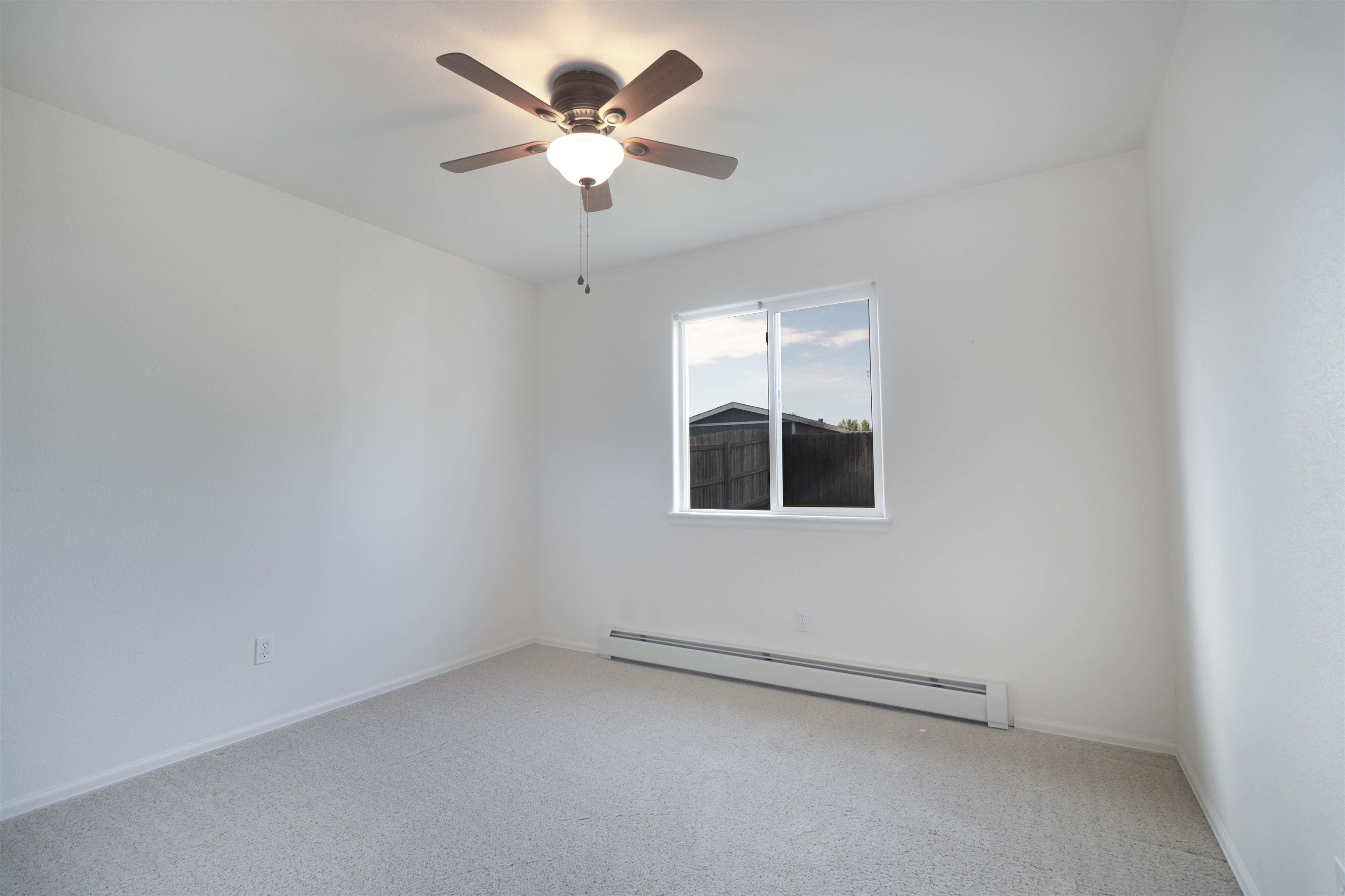 1386 Powell Street Fruita, CO 81521 - Photo 8 of 21 an empty room with a empty space and a ceiling fan