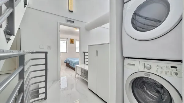 a view of a hallway with washer and dryer