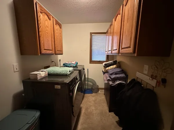 a utility room with sink dryer and washer