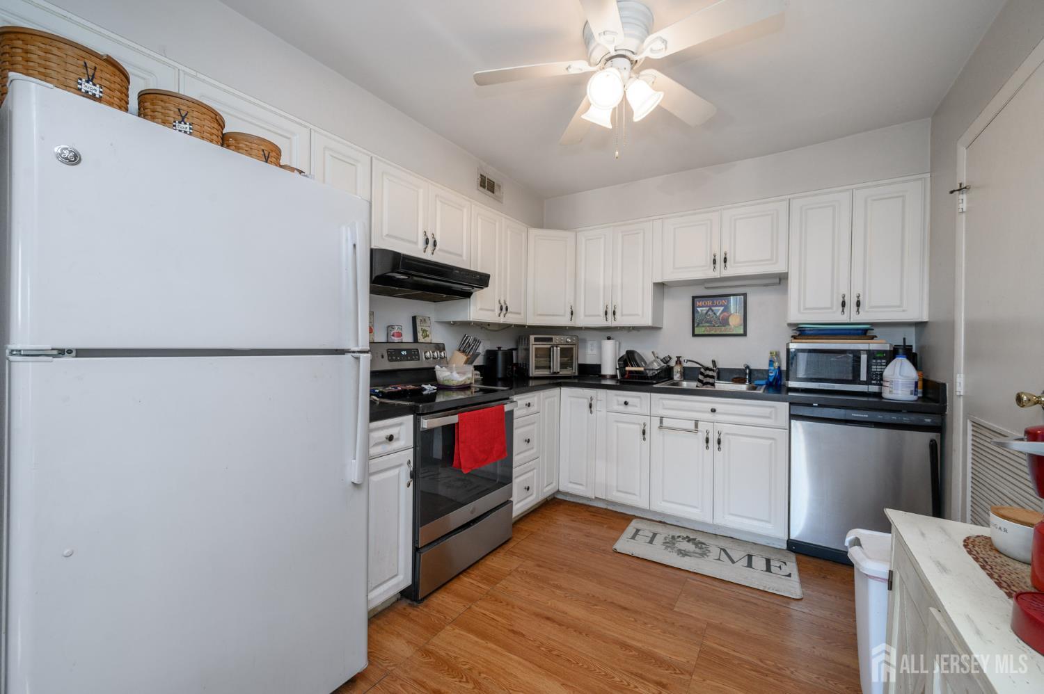 127 Chaucer Road Mount Laurel, NJ 08054 - Photo 27 of 43 a kitchen with stainless steel appliances granite countertop a refrigerator a stove a sink dishwasher and a refrigerator with wooden floor