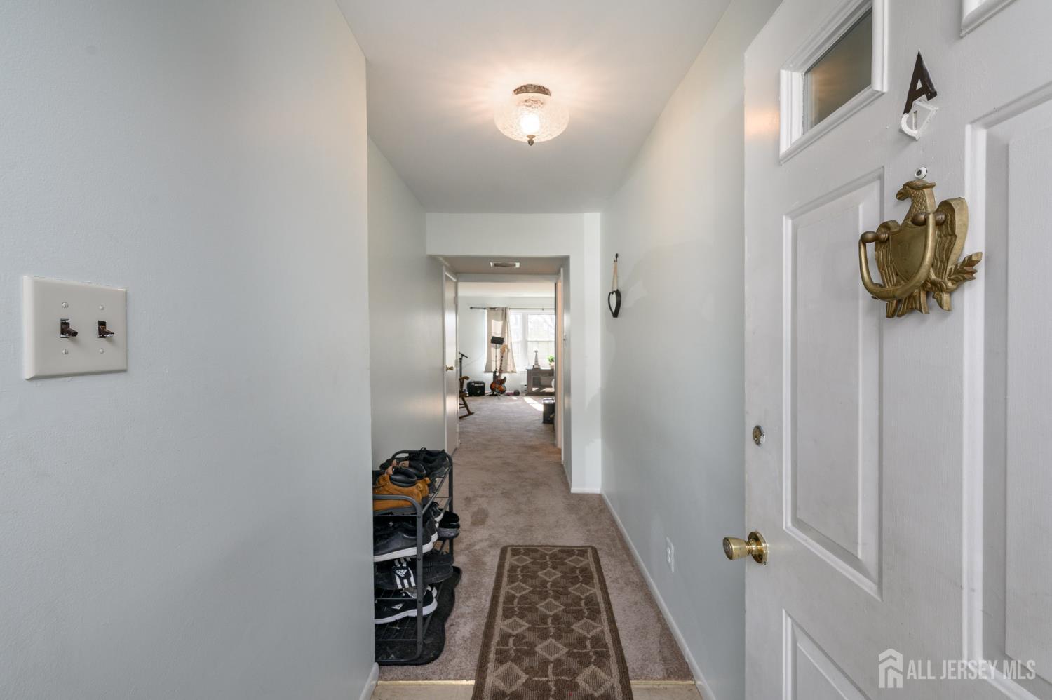 127 Chaucer Road Mount Laurel, NJ 08054 - Photo 3 of 43 a hallway with a chandelier