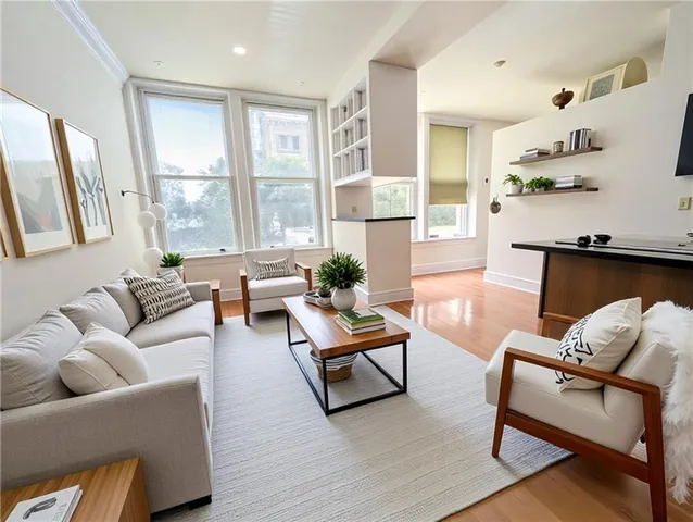 a living room with furniture and a large window