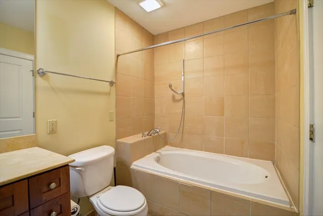 a white bath tub sitting next to a toilet