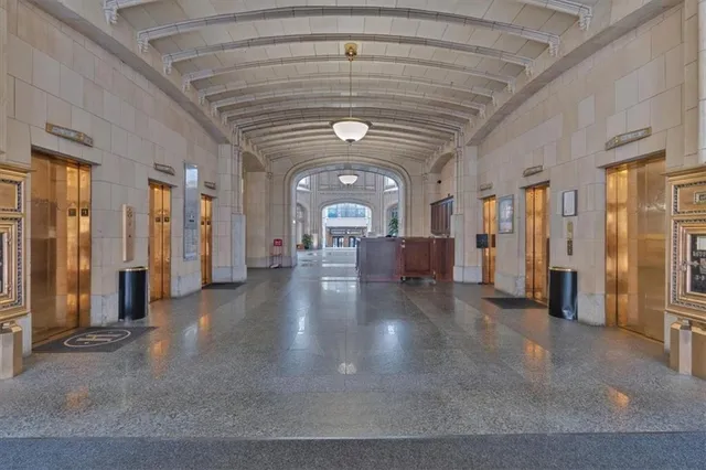 a view of a hallway with entryway wooden floor and windows