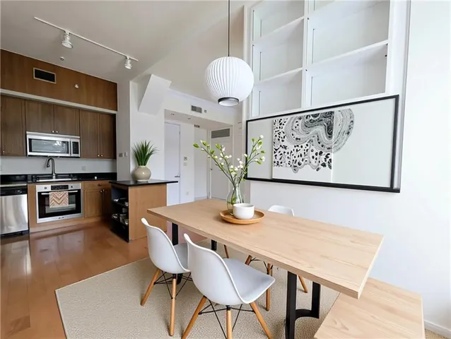 a view of a dining room with furniture and wooden floor