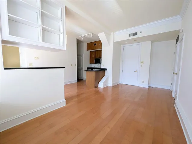 a view of a kitchen with a refrigerator cabinets and a wooden floor