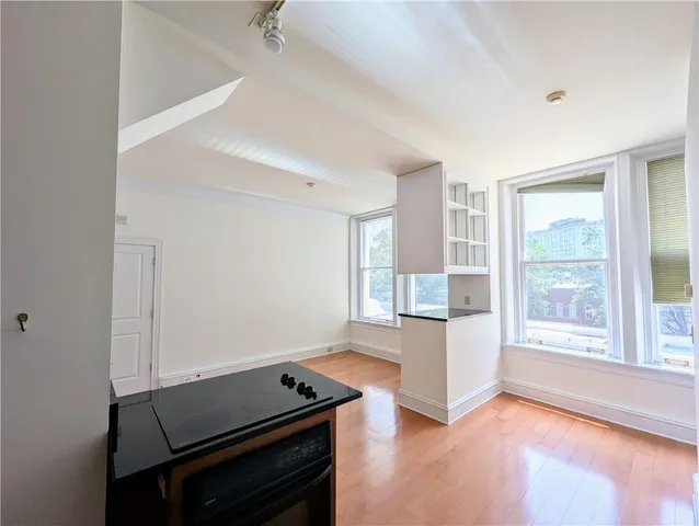 a living room with a stove and a window