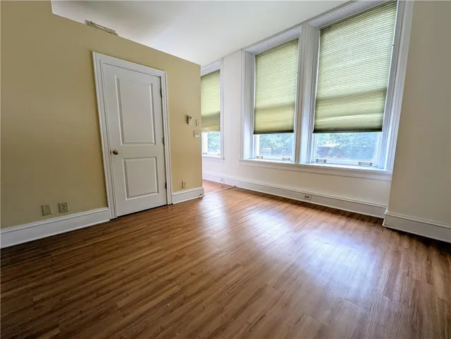 a view of a livingroom with wooden floor and window
