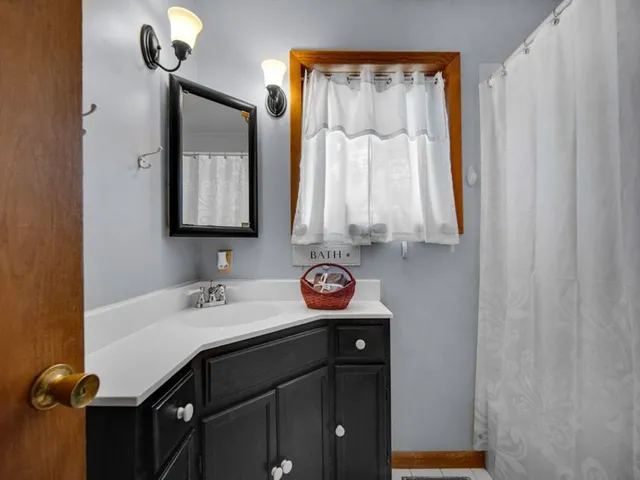 a bathroom with a sink a vanity and a mirror