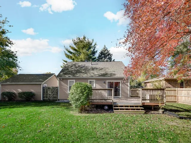 a front view of a house with a garden and plants