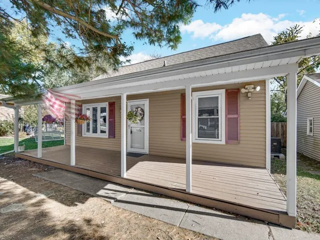 a view of a house with a door and wooden floor