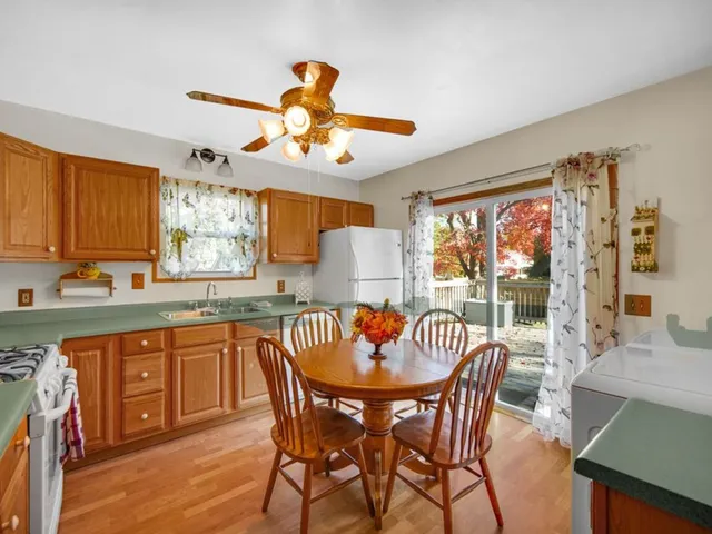 a dining room with furniture a chandelier and window