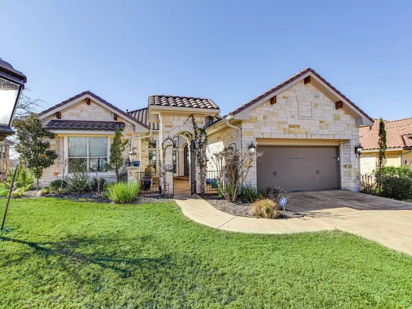 a view of a house with a yard and sitting area