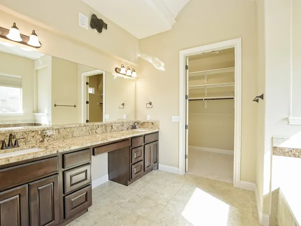 a bathroom with a granite countertop sink mirror and