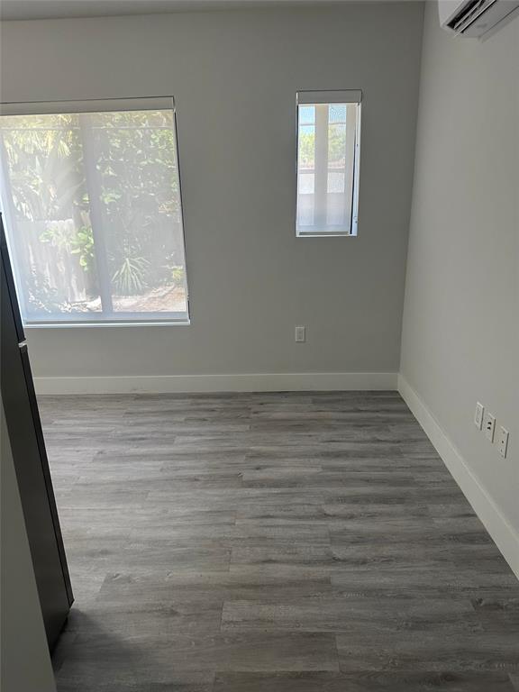 1639 Madison Street, Unit 11B Hollywood, FL 33020 - Photo 5 of 8 a view of a small space with wooden floor and a window