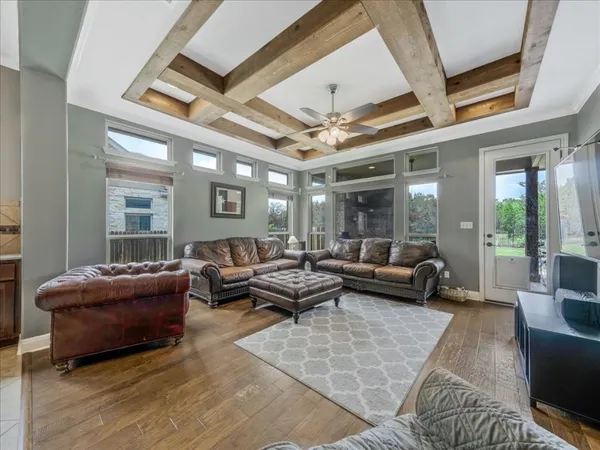 a kitchen with stainless steel appliances kitchen island granite countertop a refrigerator a stove a sink a dining table and chairs