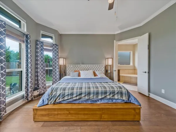 a spacious bedroom with a bed and a large window