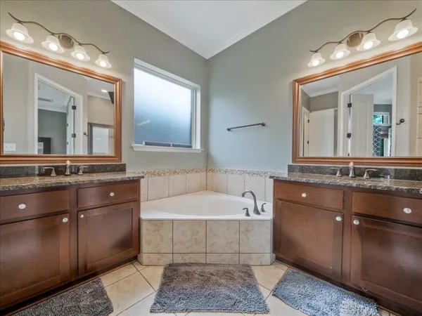 a bathroom with a sink a toilet and large mirror