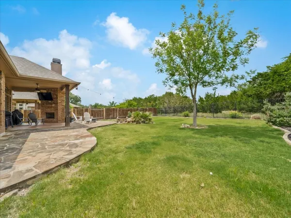 a view of a chairs and table in backyard of the house