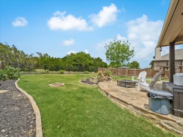 a view of a backyard with sitting area