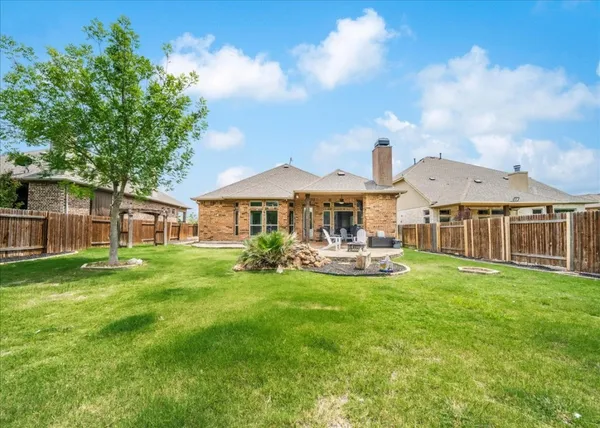a front view of a house with swimming pool having outdoor seating