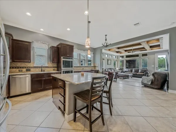 a kitchen with stainless steel appliances kitchen island granite countertop a sink and cabinets