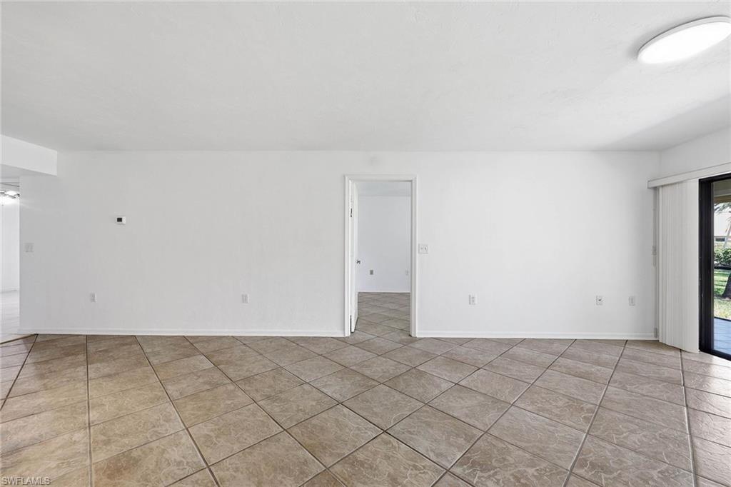1231 Commonwealth Circle, Unit Q104 Naples, FL 34116 - Photo 11 of 33 an empty room with natural light