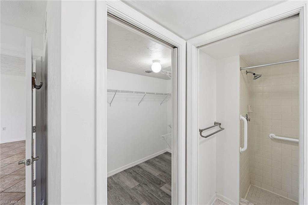 1231 Commonwealth Circle, Unit Q104 Naples, FL 34116 - Photo 23 of 33 a view of a room with wooden floor