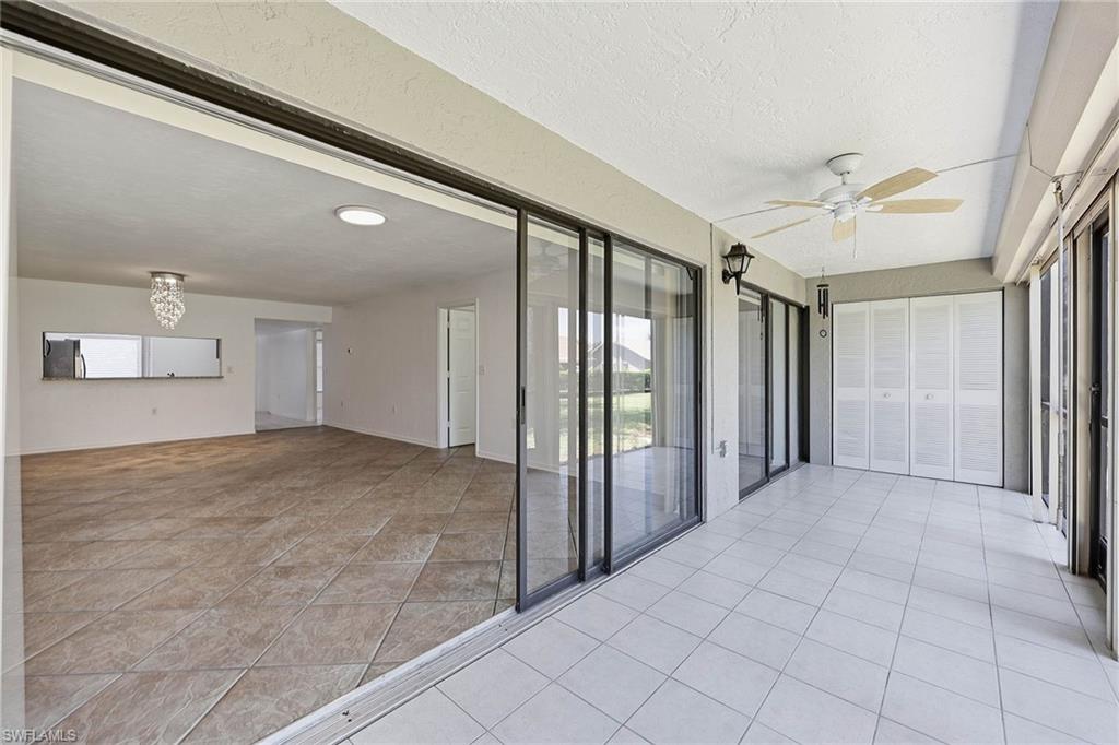 1231 Commonwealth Circle, Unit Q104 Naples, FL 34116 - Photo 28 of 33 a view of a hallway with a chandelier