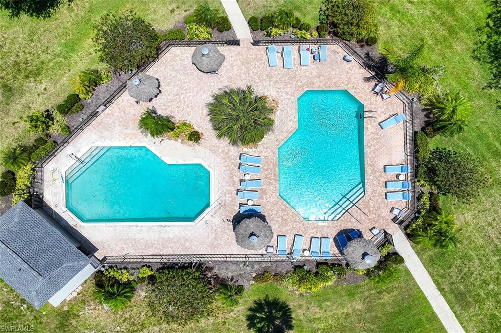 1231 Commonwealth Circle, Unit Q104 Naples, FL 34116 - Photo 32 of 33 an aerial view of a house with a swimming pool and outdoor seating