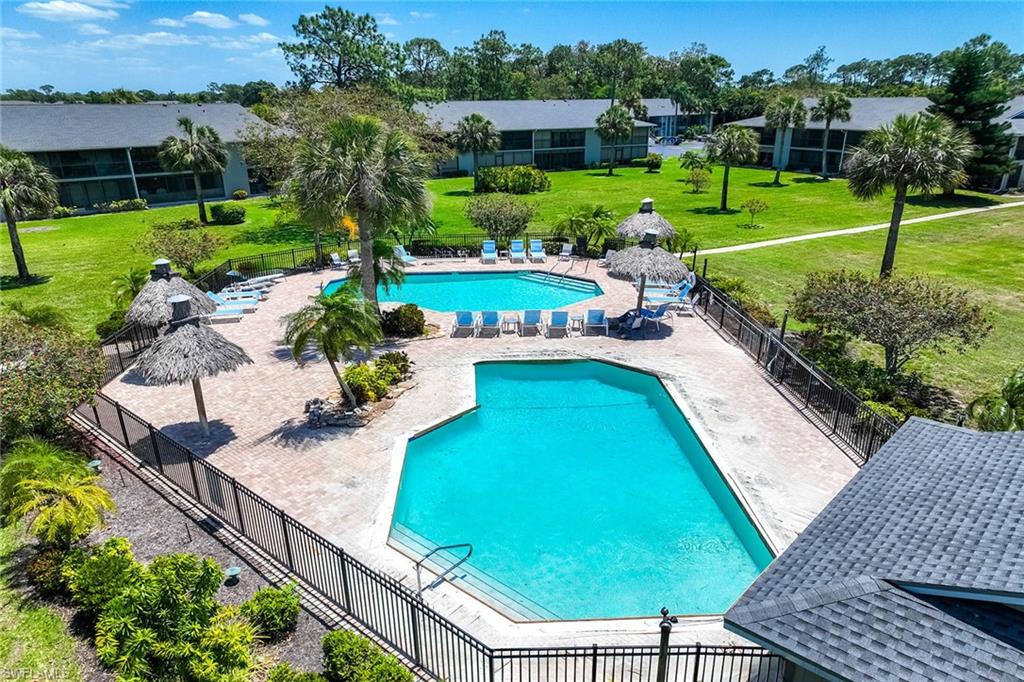 1231 Commonwealth Circle, Unit Q104 Naples, FL 34116 - Photo 33 of 33 a view of a swimming pool with a garden and seating area
