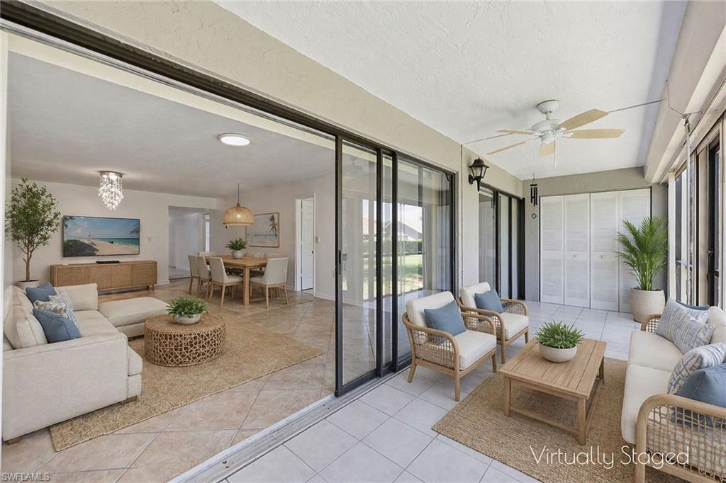 1231 Commonwealth Circle, Unit Q104 Naples, FL 34116 - Photo 6 of 33 a living room with furniture and a large window
