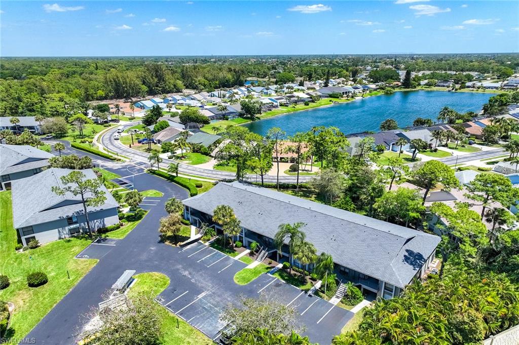 1231 Commonwealth Circle, Unit Q104 Naples, FL 34116 - Photo 7 of 33 an aerial view of a house with a lake view