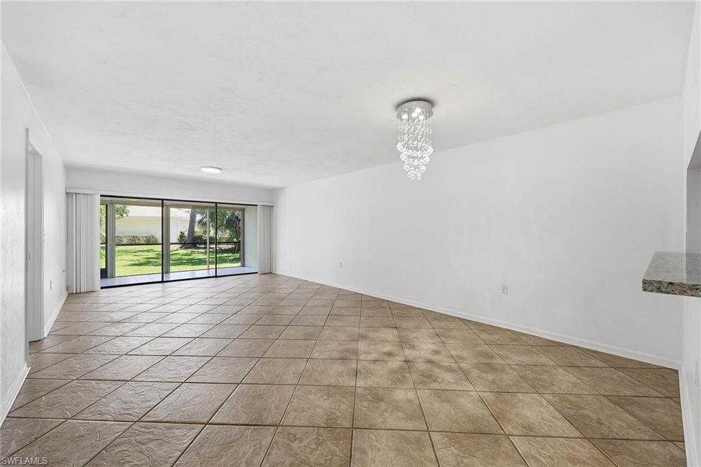1231 Commonwealth Circle, Unit Q104 Naples, FL 34116 - Photo 9 of 33 a view of an empty room with a window