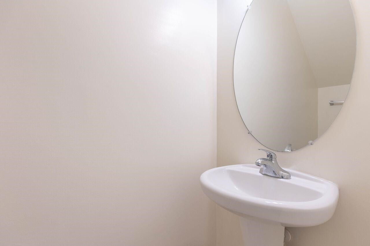 3409 Colossae Court Raleigh, NC 27610 - Photo 14 of 28 a bathroom with a sink and a mirror