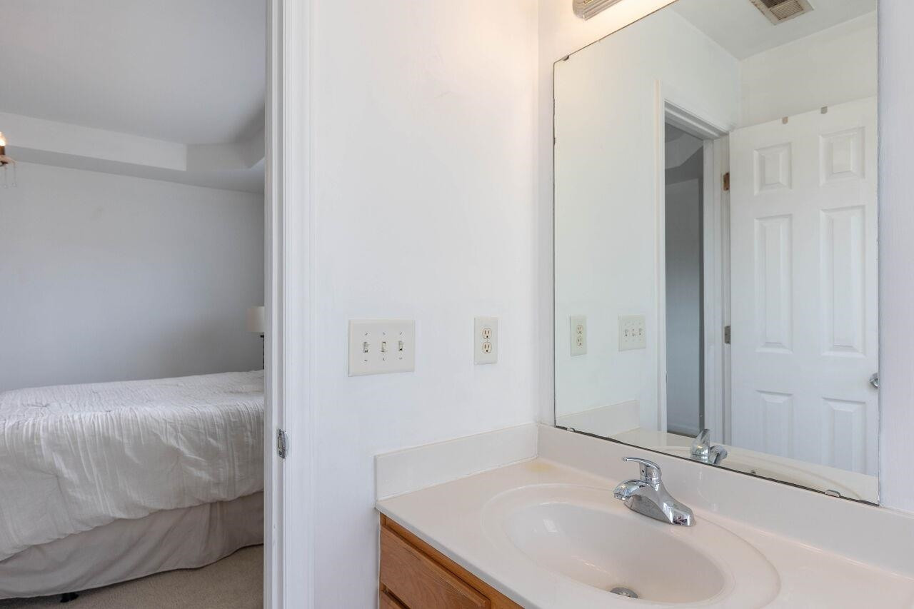 3409 Colossae Court Raleigh, NC 27610 - Photo 19 of 28 a bathroom with a sink and a mirror