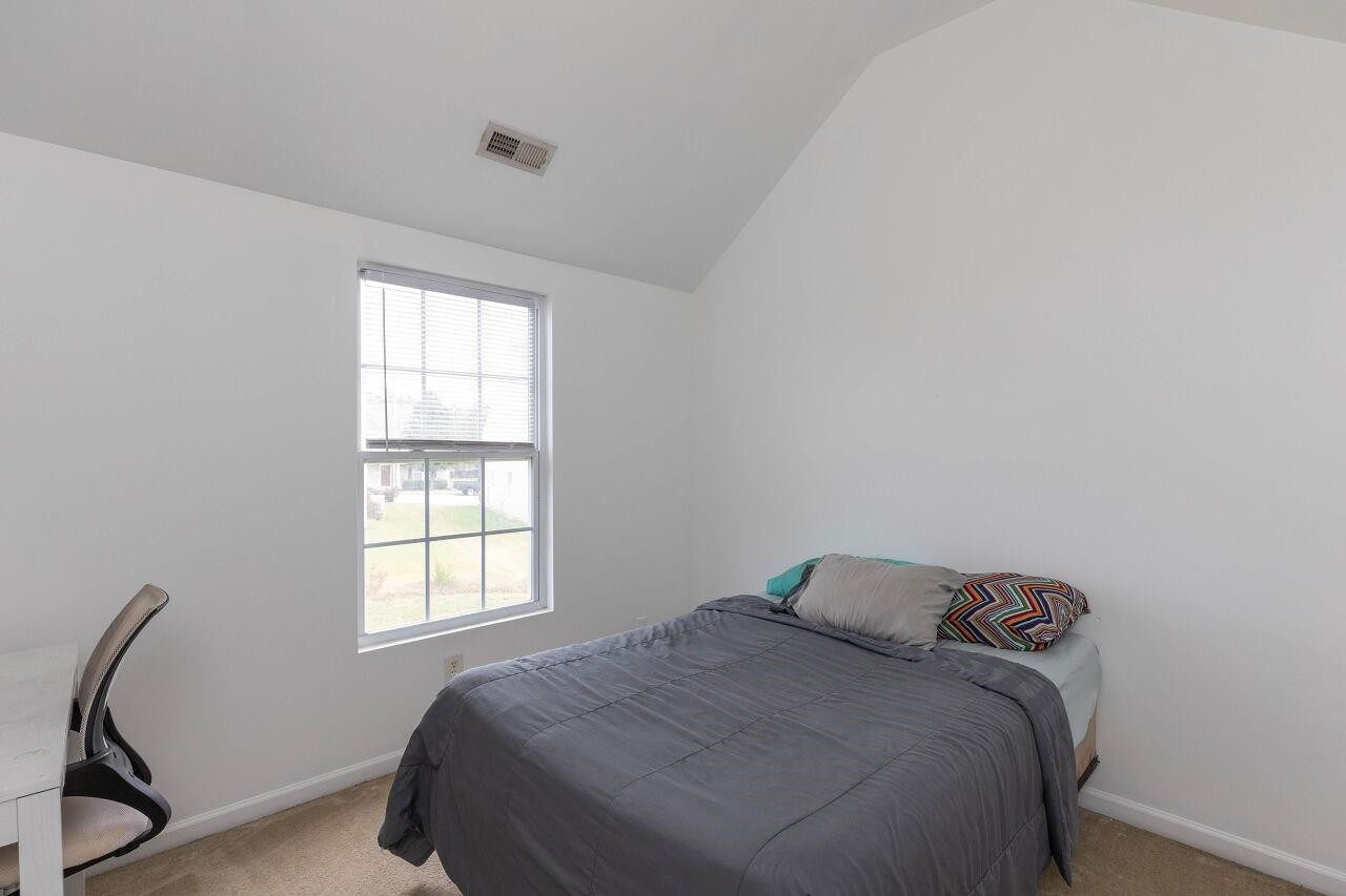 3409 Colossae Court Raleigh, NC 27610 - Photo 23 of 28 a bed sitting in a bedroom next to a window