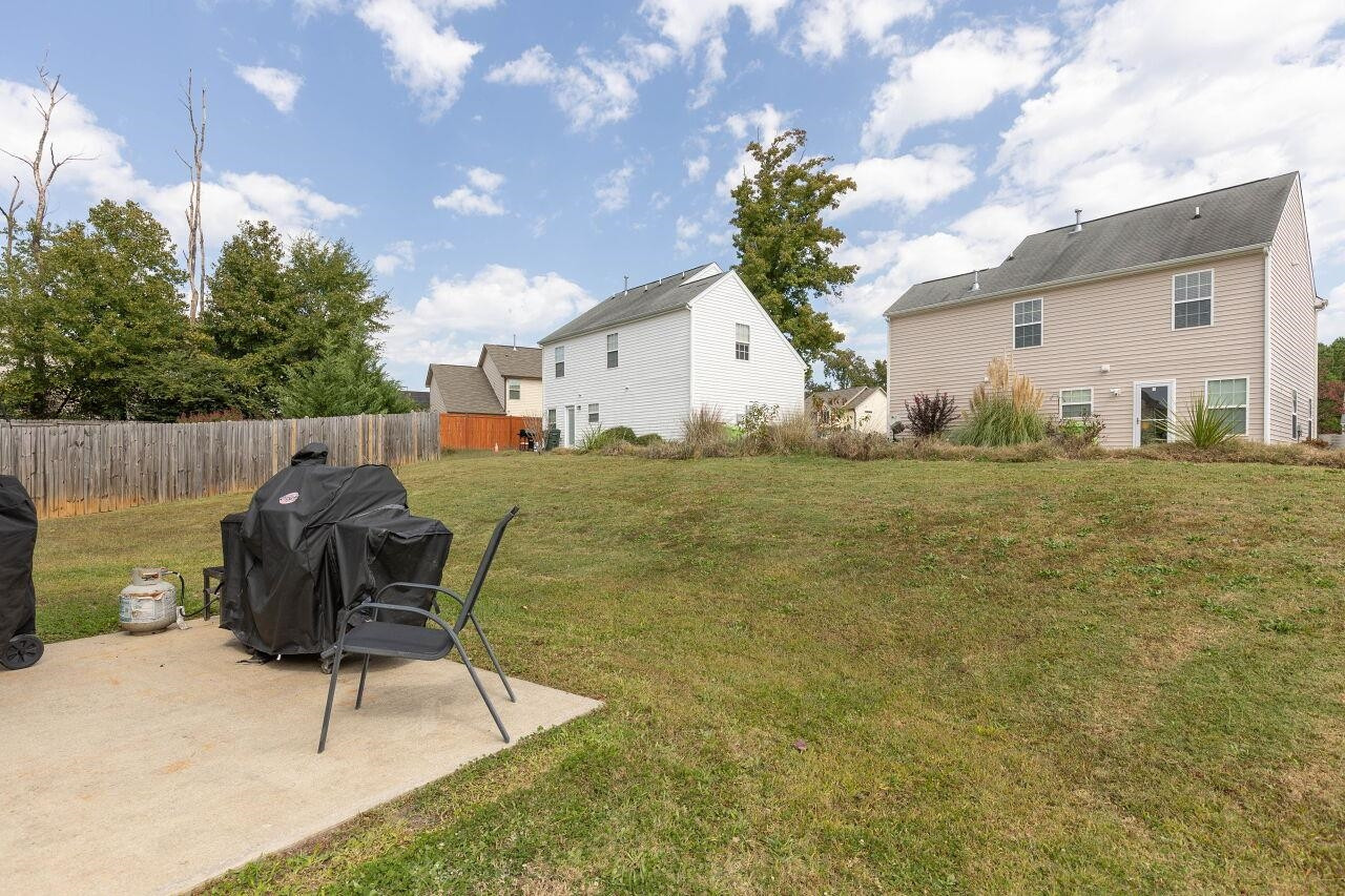 3409 Colossae Court Raleigh, NC 27610 - Photo 26 of 28 a backyard of a house with table and chairs