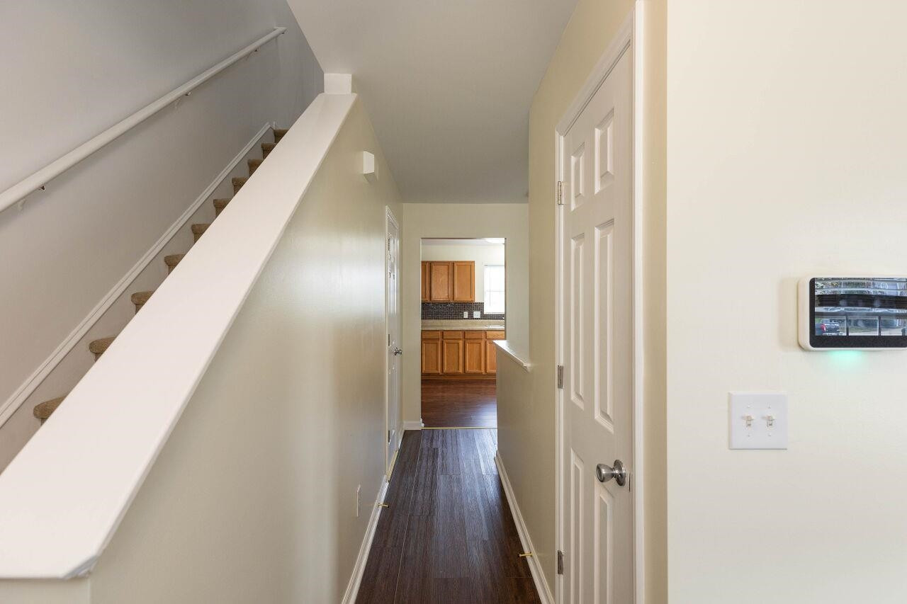 3409 Colossae Court Raleigh, NC 27610 - Photo 3 of 28 a view of a hallway with wooden floor and staircase