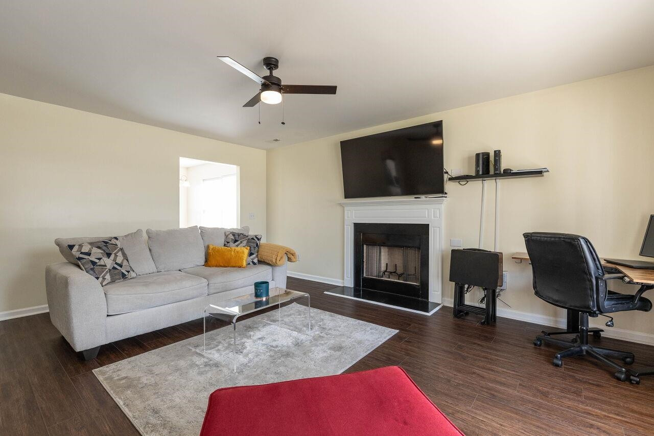 3409 Colossae Court Raleigh, NC 27610 - Photo 5 of 28 a living room with furniture and a fireplace