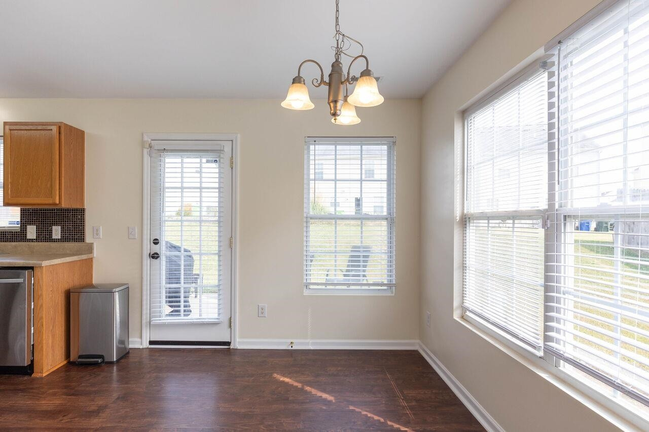 3409 Colossae Court Raleigh, NC 27610 - Photo 9 of 28 a view of an empty room with wooden floor and a window
