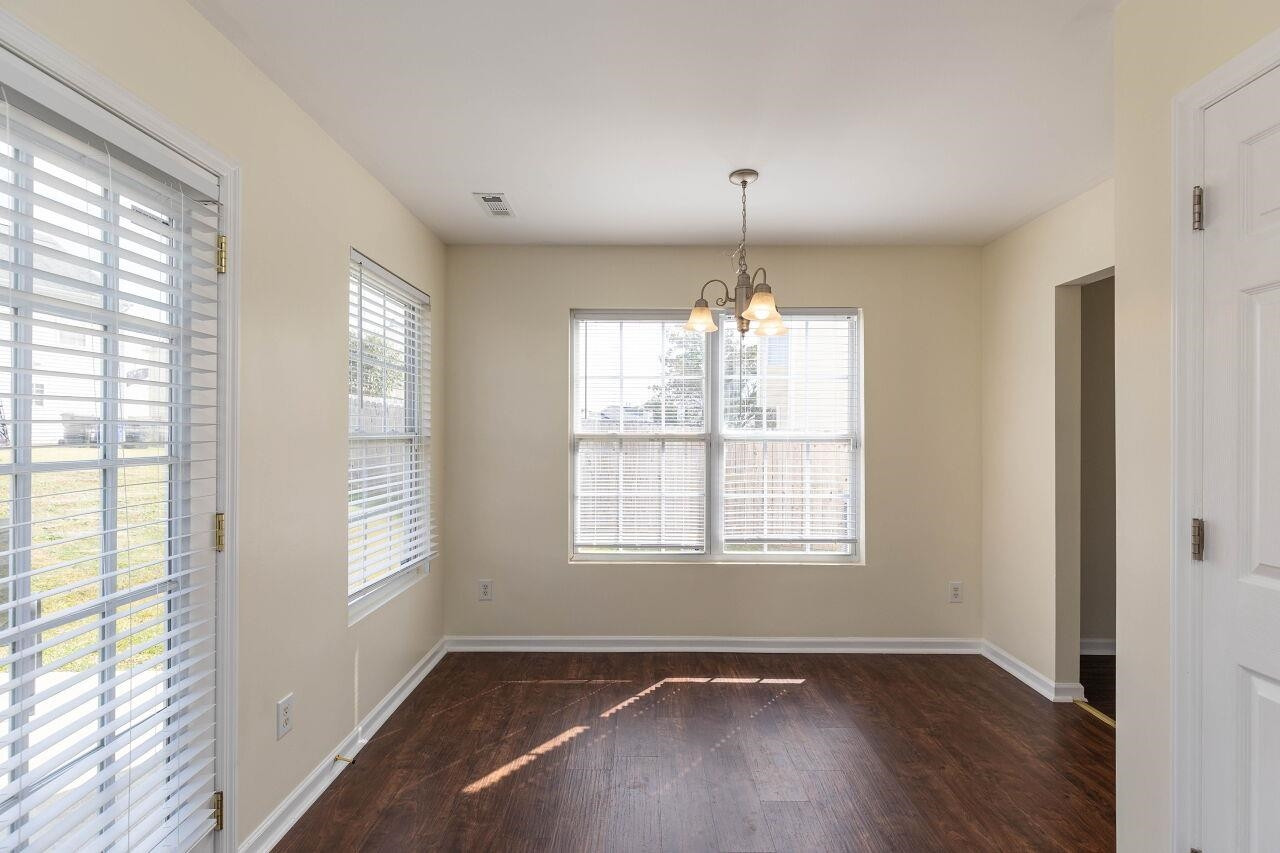 3409 Colossae Court Raleigh, NC 27610 - Photo 10 of 28 a view of an empty room with wooden floor and a window