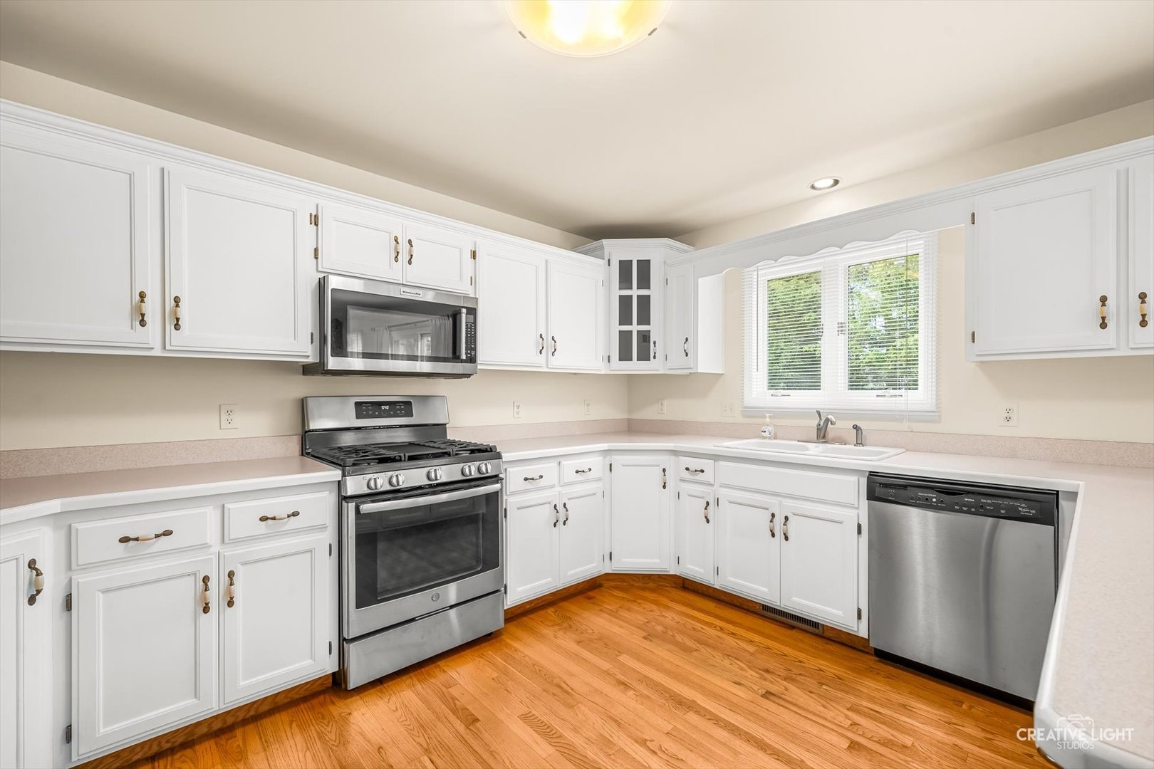 714 East Knights Road Sandwich, IL 60548 - Photo 7 of 33 a kitchen with white cabinets appliances a sink and a window