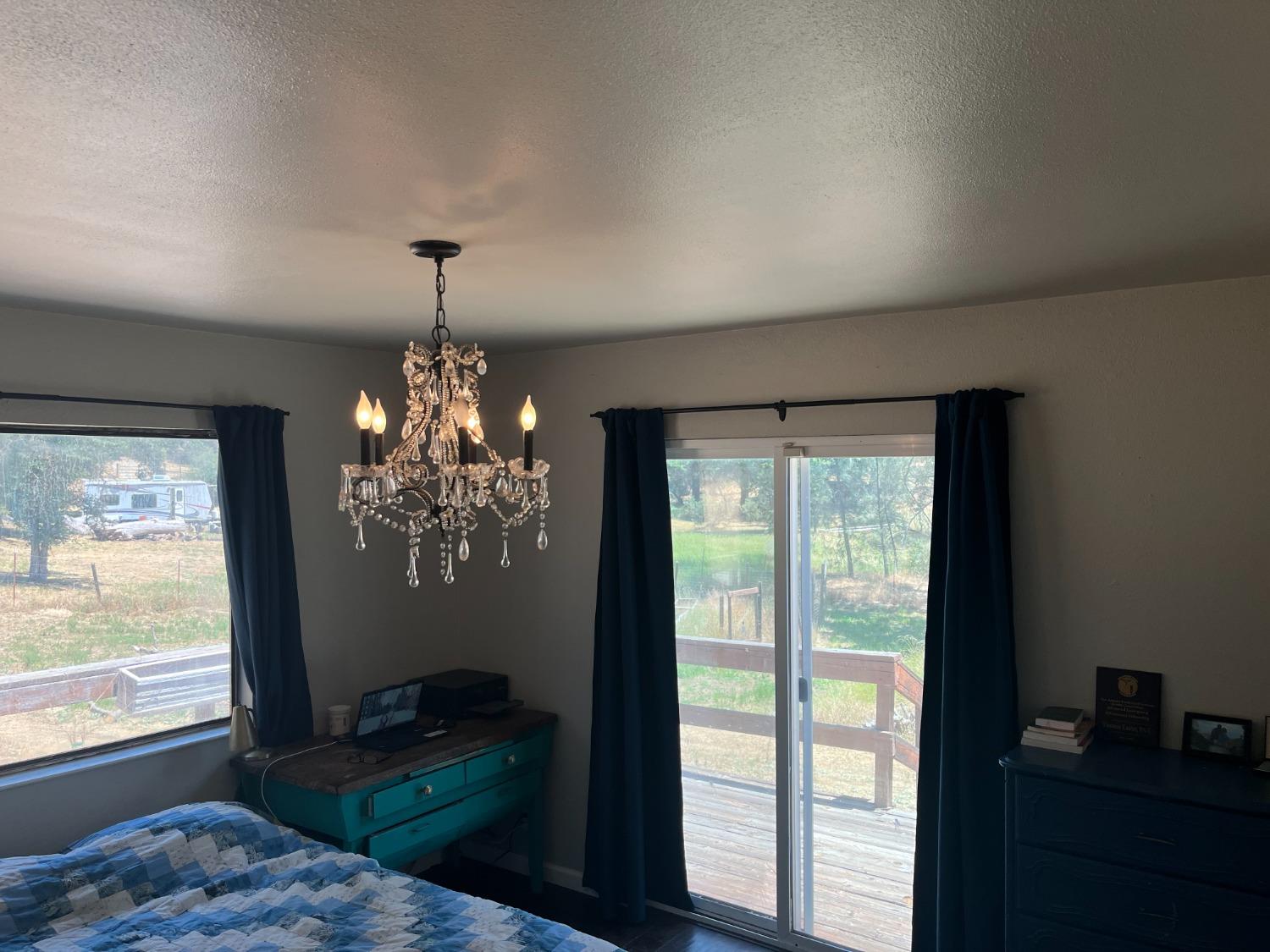 31397 Erie Road Coarsegold, CA 93614 - Photo 19 of 21 a dining room with chandelier and windows