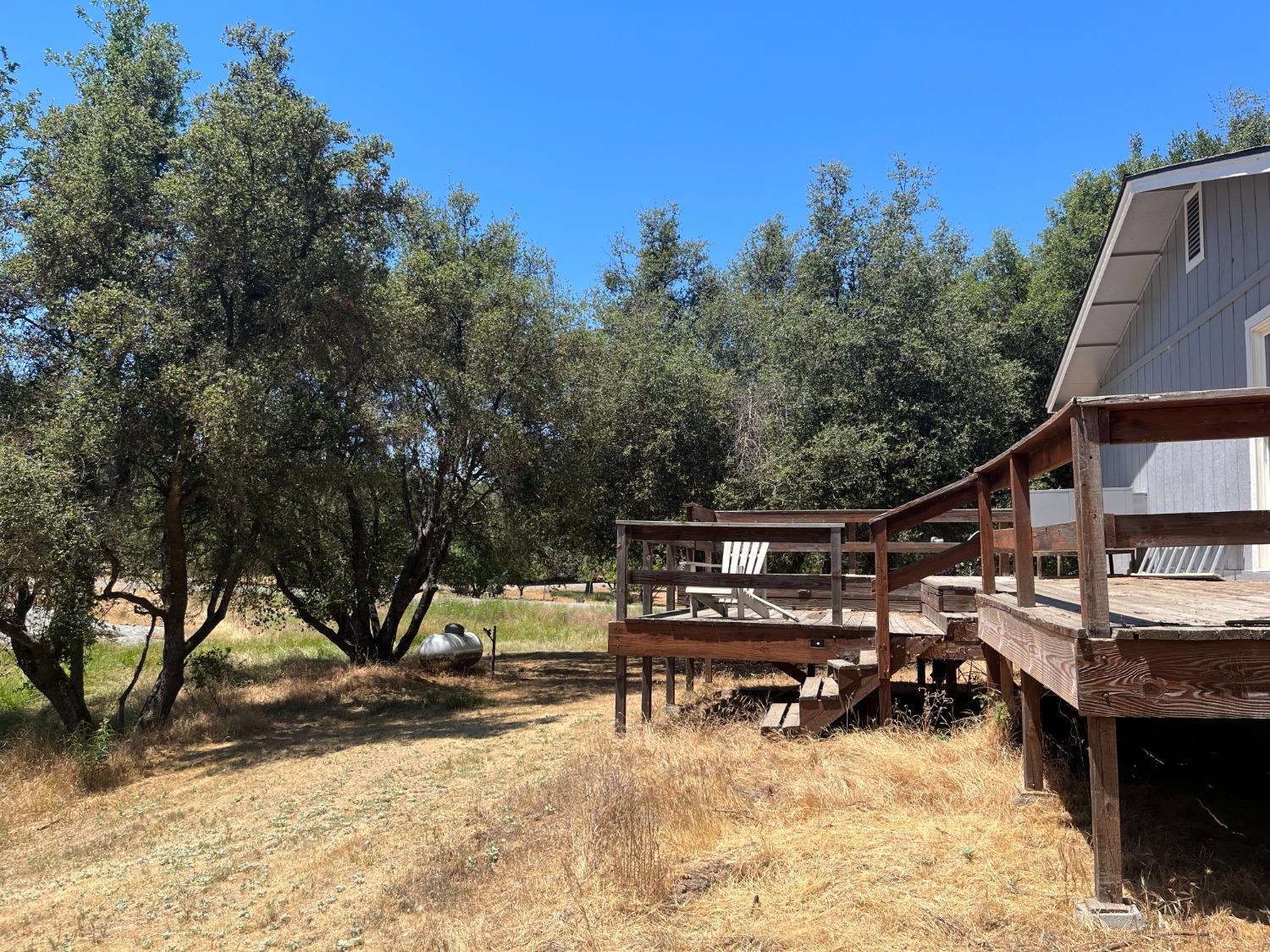 31397 Erie Road Coarsegold, CA 93614 - Photo 2 of 21 a view of roof deck with wooden fence and trees
