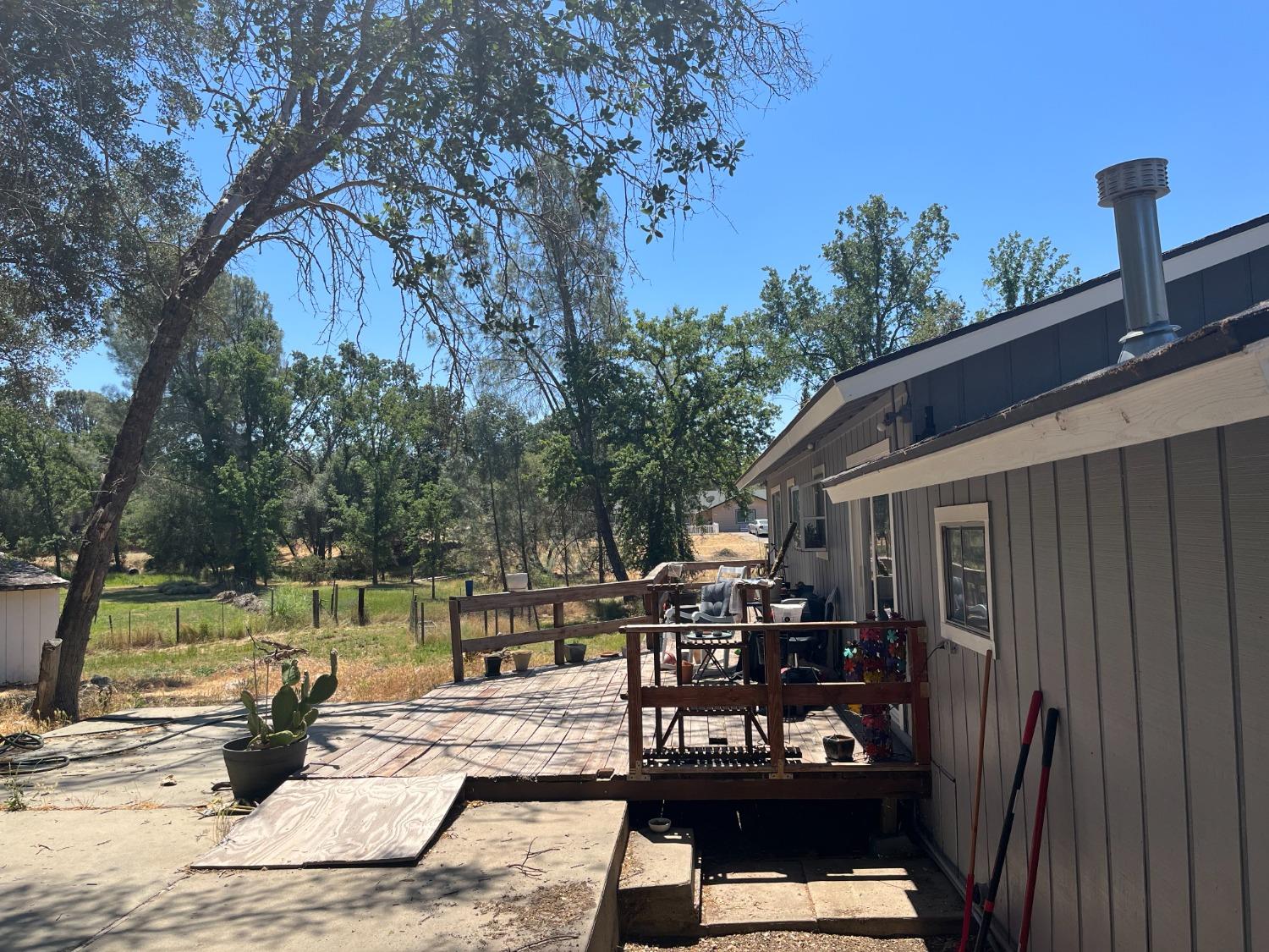 31397 Erie Road Coarsegold, CA 93614 - Photo 5 of 21 a view of a patio with couches table and chairs and potted plants