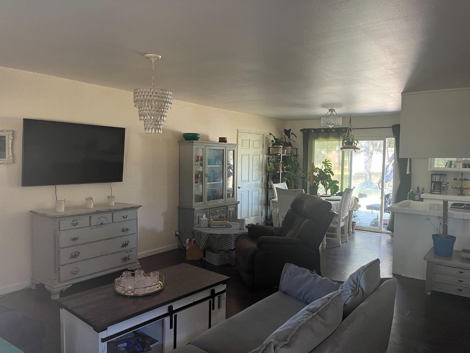 31397 Erie Road Coarsegold, CA 93614 - Photo 8 of 21 a living room with furniture a flat screen tv and kitchen view